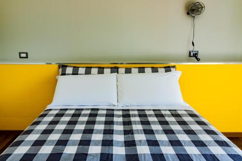 a bed with a black and white checkered blanket at TRAVEL STATION Bedandbreakfast in Bari