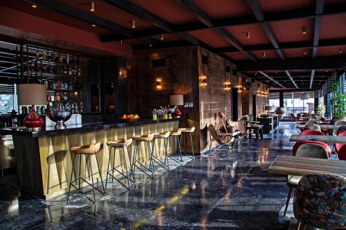 a bar in a restaurant with stools at Carus Cappadocia in Goreme