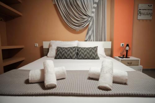 a bedroom with a white bed with two pillows at casa al mare in Kavála