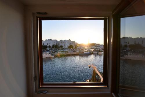 a window with a view of a body of water at Il b&b di Alice in Monopoli