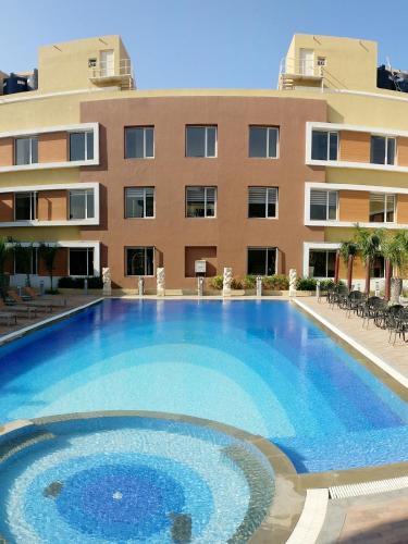 a large swimming pool in front of a building at Club Mahindra Dwarka in Dwarka
