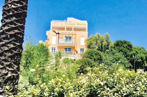 a building with a sign on the side of it at Le Terrazze Mordini in La Maddalena