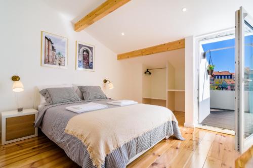 a bedroom with a bed and a large window at In2Lisbon - Kionga Suites in Lisbon