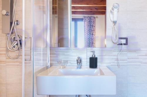 a bathroom with a sink and a mirror at LE API in Cagliari