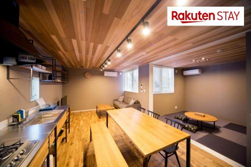 a kitchen and living room with a wooden ceiling at Rakuten STAY HOUSE × WILL STYLE Matsue in Matsue