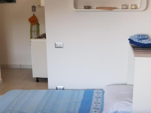 a bedroom with a bed with a blue blanket at ele&gio accomodation in Tropea
