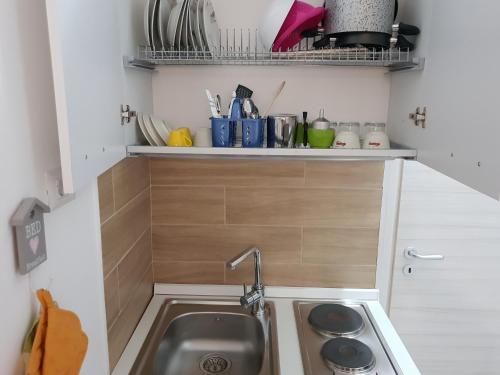 a small kitchen with a sink and a counter at ele&gio accomodation in Tropea