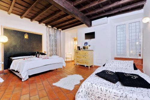 a large bedroom with two beds and a dresser at 3Chic Maison Colosseo in Rome