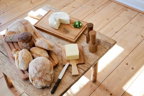 a table with different types of bread and cheese at Hotel & Restaurant Linde in Münstertal