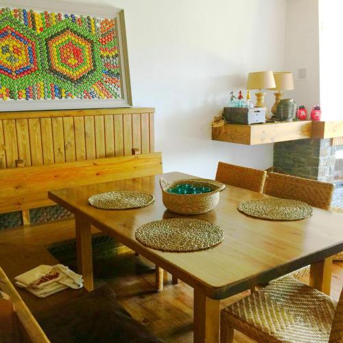 a dining room table with chairs and a painting on the wall at OLOPTE I in Olopte
