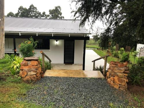 a house with a wooden walkway in front of it at Newstead Farm - Country Cottages in Curryʼs Post