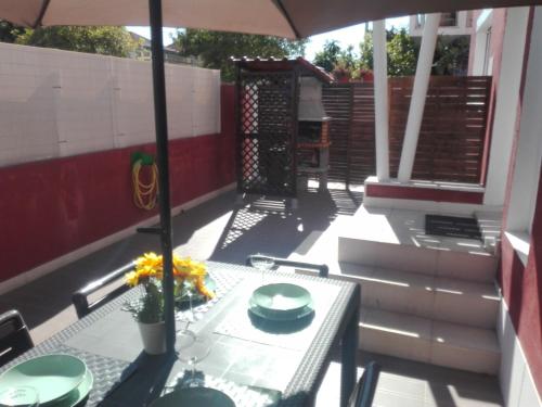 a table on a balcony with an umbrella at Lisbon Beach Apartments 1 in Costa da Caparica