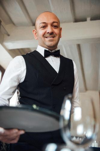 a man wearing a tuxedo and a bow tie at Rossano Boutique Hotel & Ristorante in Ansbach