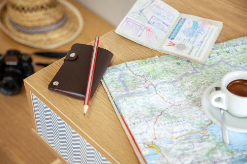 a table with a map and a notebook and a cup of coffee at Ibis Styles Brindisi in Brindisi