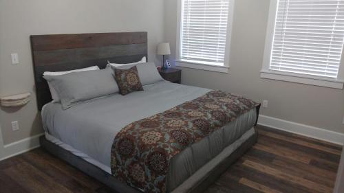 a bedroom with a large bed with a wooden headboard at Wildflower Bed and Breakfast in Mountain View