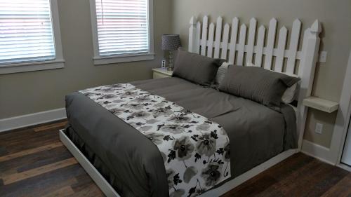 a bedroom with a large bed with a white headboard at Wildflower Bed and Breakfast in Mountain View