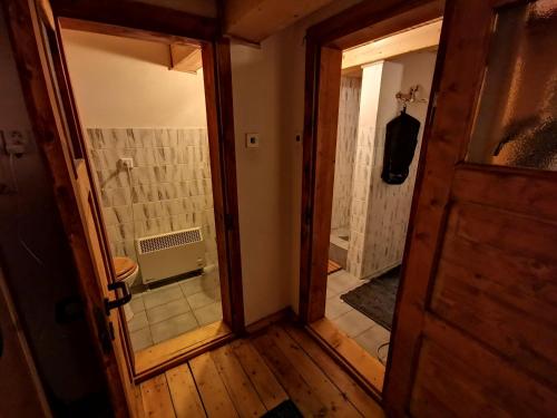 an open door to a bathroom with a walk in shower at Chata Telgart in Telgárt