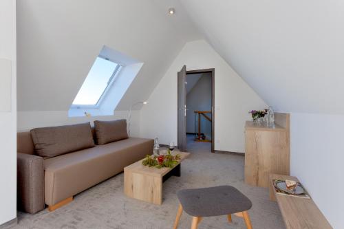 a living room with a couch and a table at Düne 74 in Ostseebad Karlshagen