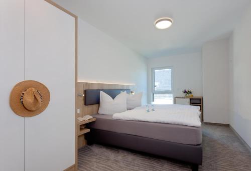 a bedroom with a bed and a mirror at Düne 74 in Ostseebad Karlshagen
