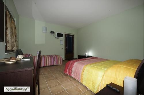 a hotel room with a bed and a table and a room at Il Frantoio in Lapedona