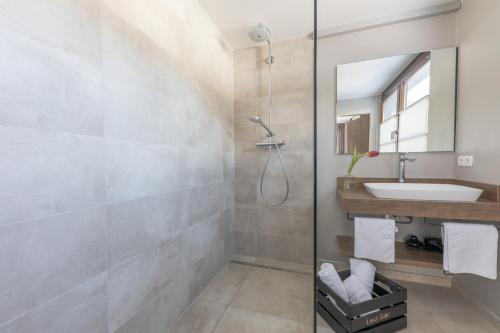 a bathroom with a sink and a shower at LakeSide Apartments Seefeld in Seefeld in Tirol