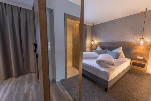 a bedroom with a bed and a sliding glass door at LakeSide Apartments Seefeld in Seefeld in Tirol