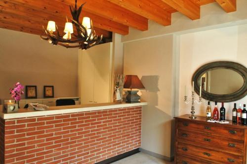 a brick bar with a mirror and a dresser at Agriturismo Le Vai in Bardolino
