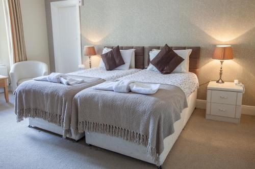 a bedroom with a large bed with white sheets and pillows at The Hotel Balmoral - Just for Adults in Torquay