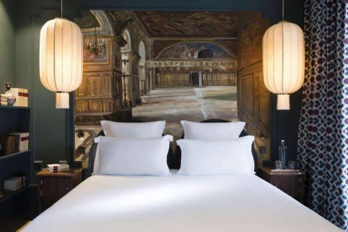 a bedroom with a large bed with two white pillows at Hôtel Monte Cristo in Paris