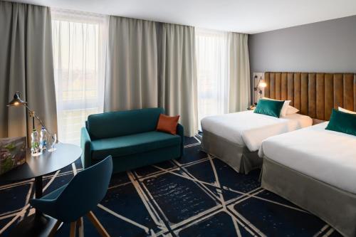 Un ou plusieurs lits dans un hébergement de l'établissement Hotel Mercure Poznań Centrum