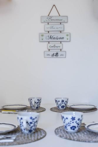 a table with blue and white cups and plates at Casali Marchigiani - Ville vacanza private con piscina in Ostra