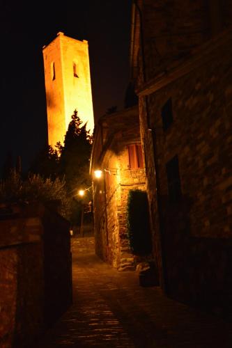 a building with a clock tower at night at Due Torri in San Severino Marche