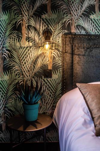 a bedroom with a potted plant on a table at La villa 10 HÔTEL SPA in Étretat