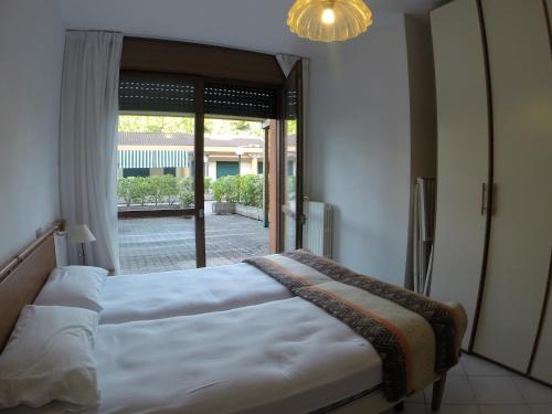 a bedroom with a bed and a large window at Corallo Cavallino in Cavallino-Treporti