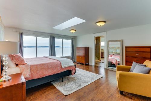 a bedroom with a bed and a couch and a chair at Bay Street Oasis in Port Orchard