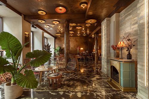 a room with tables and chairs and a fireplace at Hôtel La Nouvelle République & Hammam in Paris