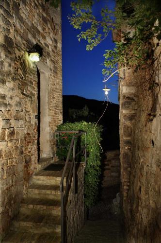 an alley with stairs and a street light at night at Due Torri in San Severino Marche