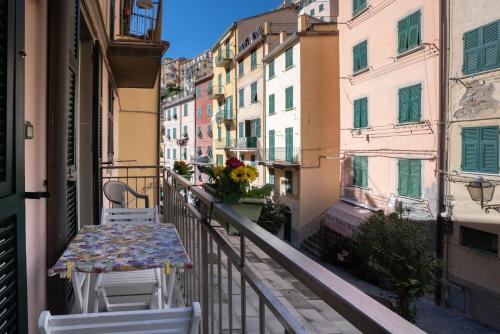 a balcony with a table and chairs and buildings at Da Elisa in Riomaggiore