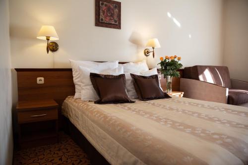a hotel room with a bed with two pillows at Hotel Panorama in Ostrowiec Świętokrzyski