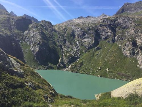 a mountain lake in the middle of a mountain range at Piccolo Hotel in Locarno