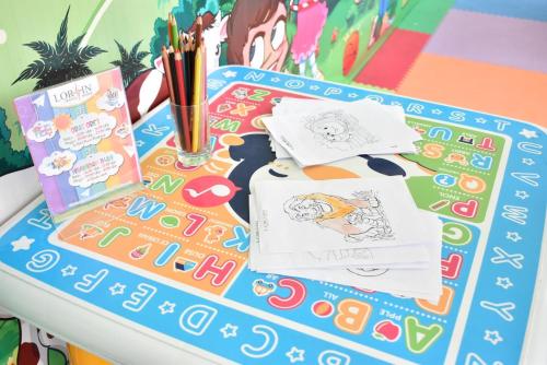 a table with drawings and pencils on it at Lorin Sentul Hotel in Bogor