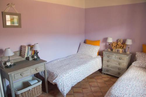 a bedroom with two twin beds and a desk at Podere Piandicava in Castelnuovo di Val di Cecina