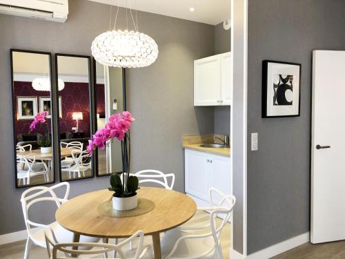 a kitchen and dining room with a table and chairs at Hotel Les Suites - Domaine de Crécy in Crecy la Chapelle