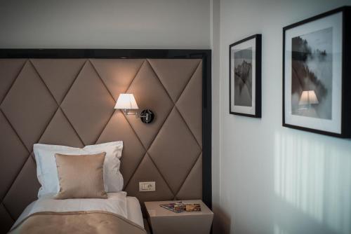 a bedroom with a bed with a brown headboard at Element in Alba Iulia