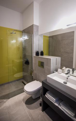 a bathroom with a toilet and a sink and a shower at Element in Alba Iulia