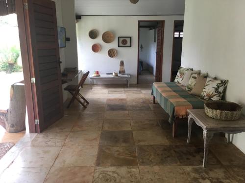 a living room with a couch and a table at Os Navegantes B in Guajiru