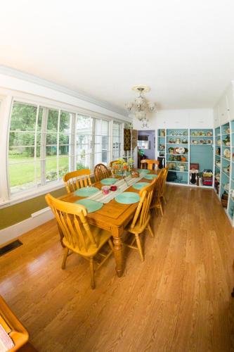 a dining room with a wooden table and chairs at Oak Park Inn in Whitehall