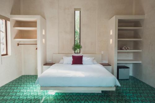 מיטה או מיטות בחדר ב-Hotel Holistika Tulum
