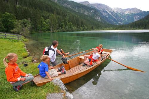 a group of children sitting on a boat on a lake at Haus am Lift in Kleinarl