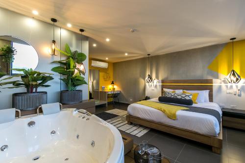 a bedroom with a bed and a bath tub at Epic Boutique Hotel in Medellín